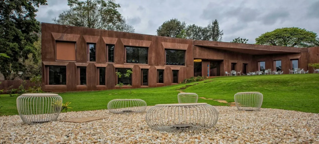 The Swiss Chancery in Nairobi: a rust-red building with deep-set windows above a sloping lawn
