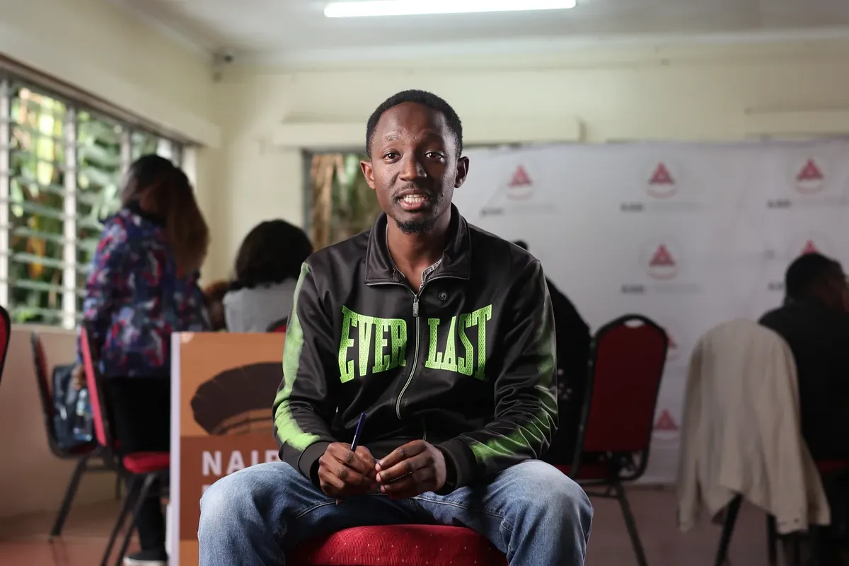 A participant interviewed in front of the Nairobi Biennale banner