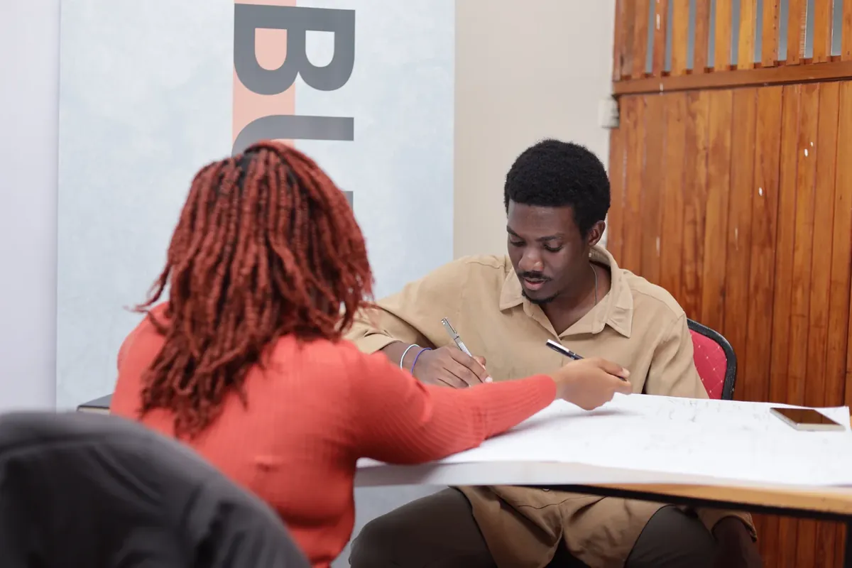 Two participants sketching together at a Biennale design workshop