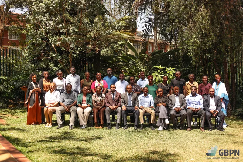 Group photo of workshop participants in a garden, with the Global Buildings Performance Network (GBPN) logo