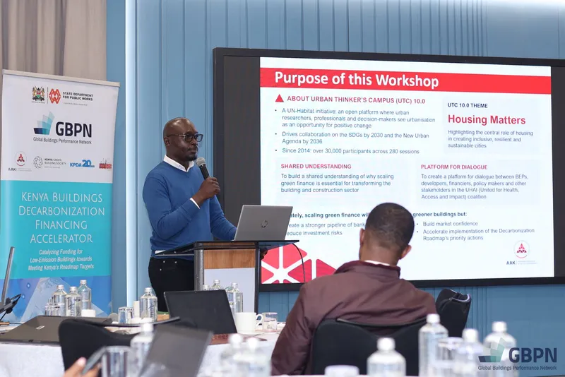 A speaker presents the slide “Purpose of this Workshop” on Urban Thinkers Campus 10.0 and its theme “Housing Matters”, beside a Kenya Buildings Decarbonization Financing Accelerator banner