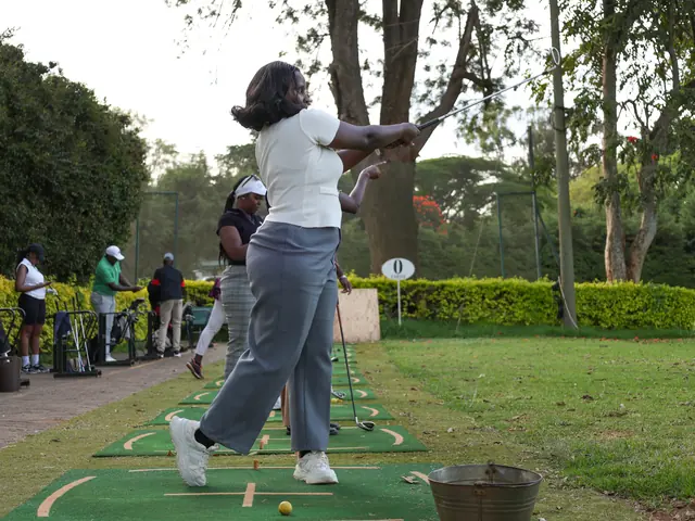 A newcomer tries her swing on the driving range