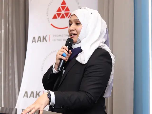 A speaker addresses the room