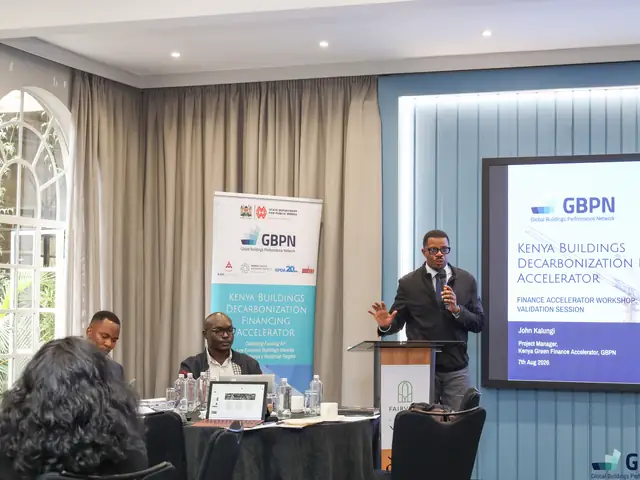 A presenter at the podium beside the GBPN slide