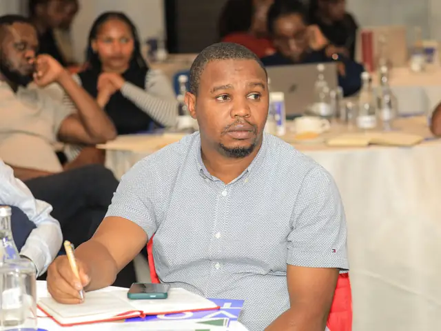 A participant takes notes