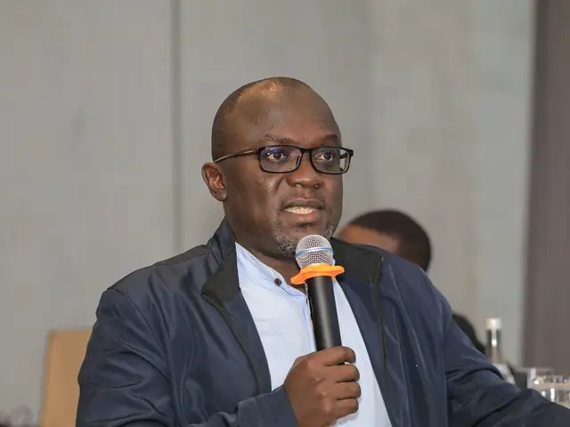 A participant speaks from his table