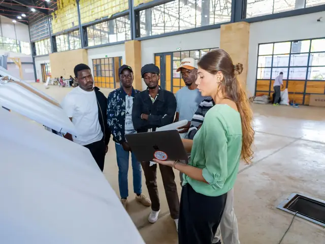 Visitors discuss a project at an exhibition stand