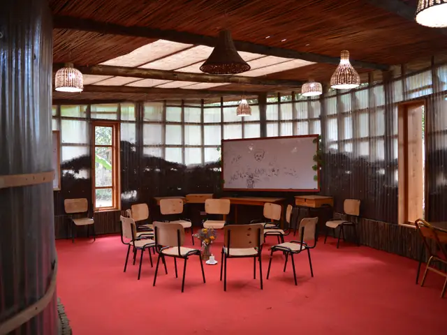 Inside a classroom: chairs arranged on a red carpet