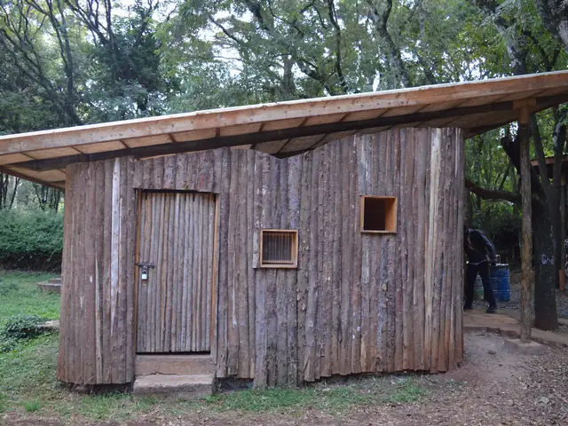 A small timber cabin with a sloping roof